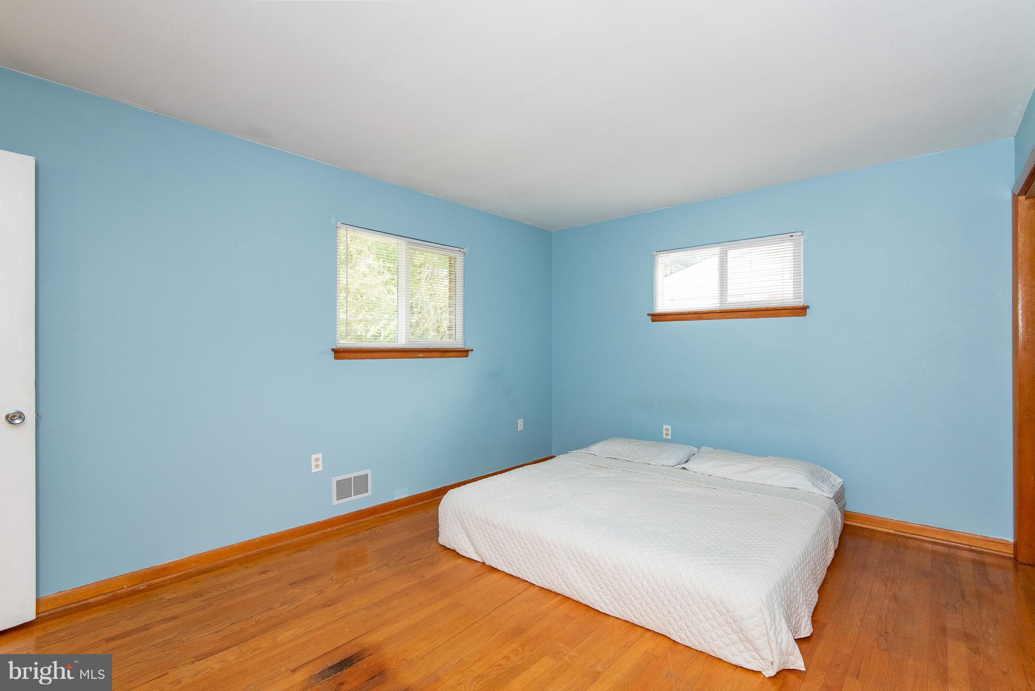 615 Eliot Road Pasadena, MD 21122 - Photo 17 of 43 a bed room with a bed and two window