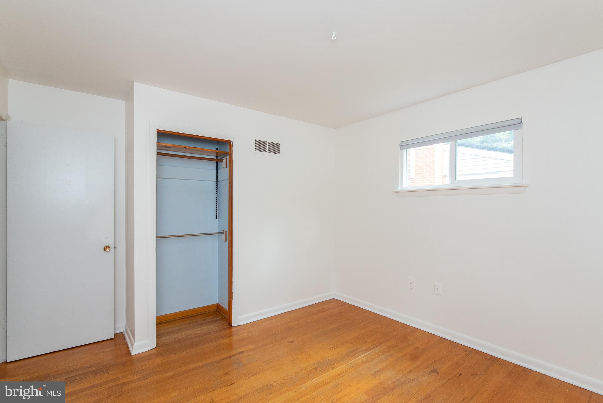 615 Eliot Road Pasadena, MD 21122 - Photo 23 of 43 an empty room with wooden floor and closet