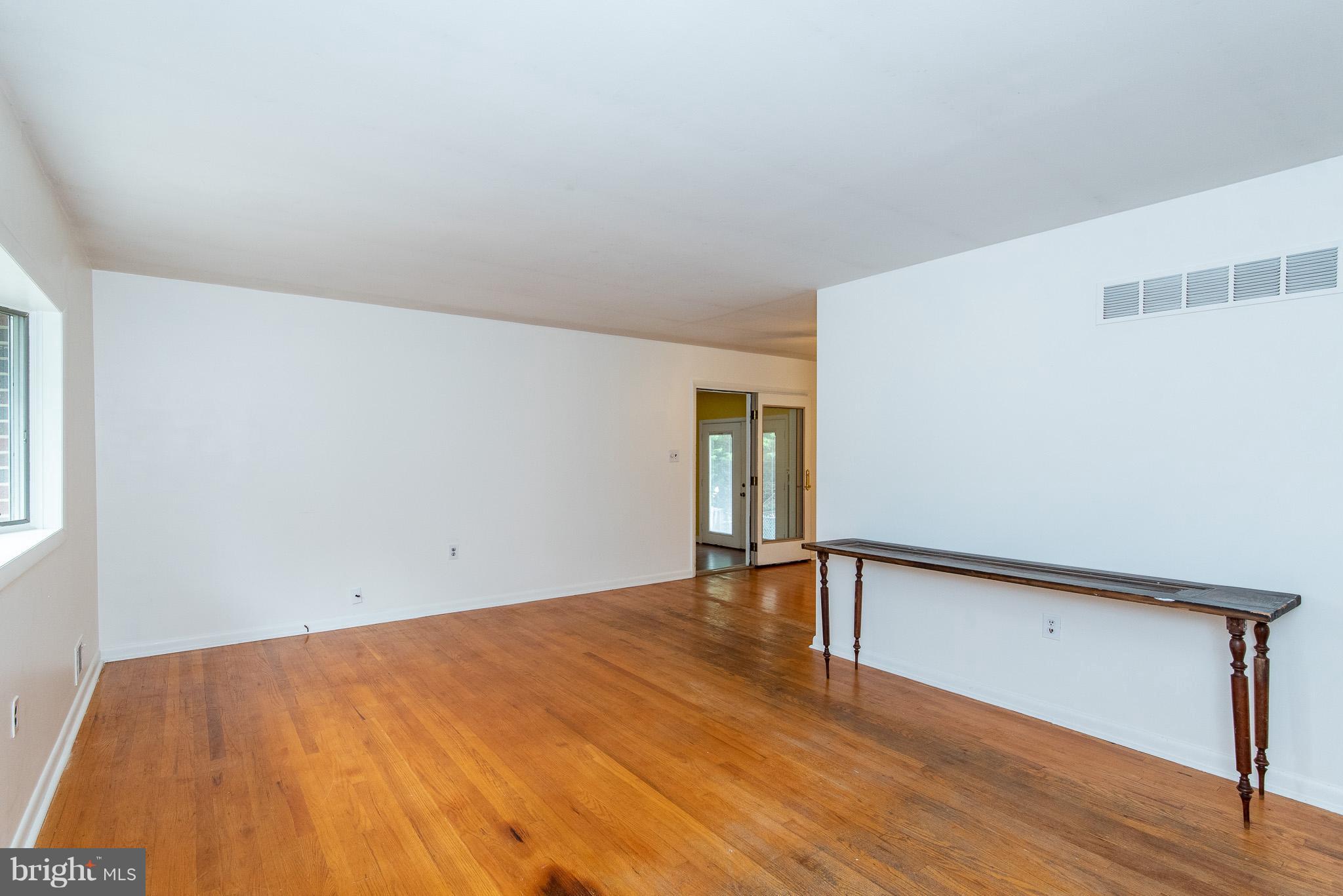 615 Eliot Road Pasadena, MD 21122 - Photo 4 of 43 a view of empty room with wooden floor