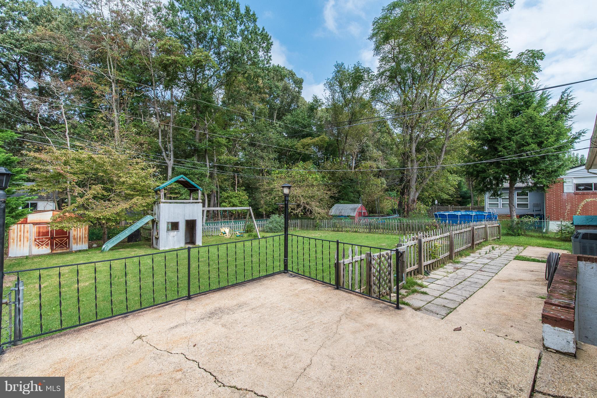 615 Eliot Road Pasadena, MD 21122 - Photo 38 of 43 a view of a deck with a large trees
