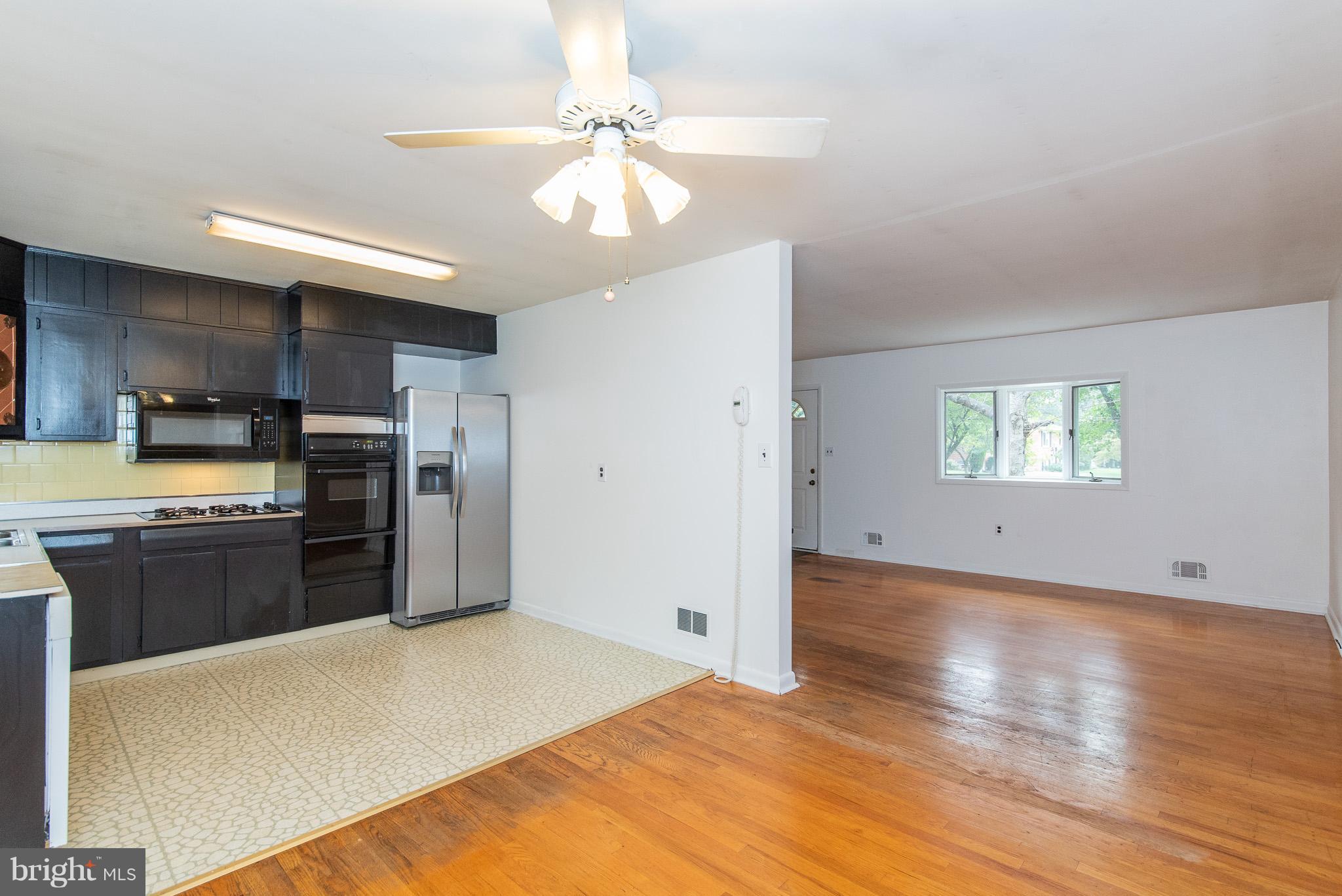 615 Eliot Road Pasadena, MD 21122 - Photo 6 of 43 a kitchen with stainless steel appliances granite countertop a refrigerator a stove a sink dishwasher and a oven with wooden floor