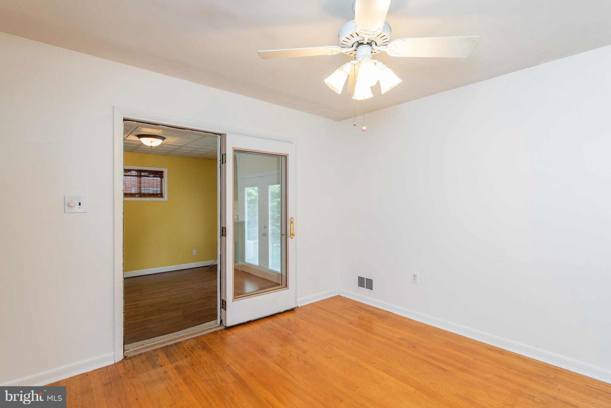 615 Eliot Road Pasadena, MD 21122 - Photo 7 of 43 an empty room with closet and a chandelier fan