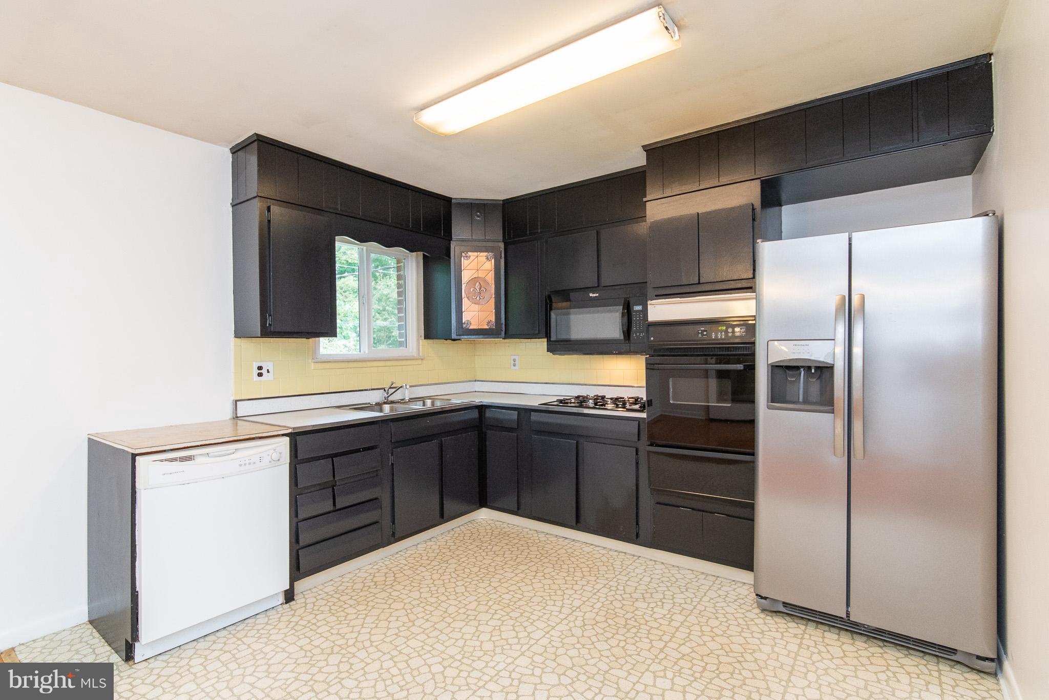 615 Eliot Road Pasadena, MD 21122 - Photo 9 of 43 a kitchen with stainless steel appliances granite countertop a refrigerator and a stove