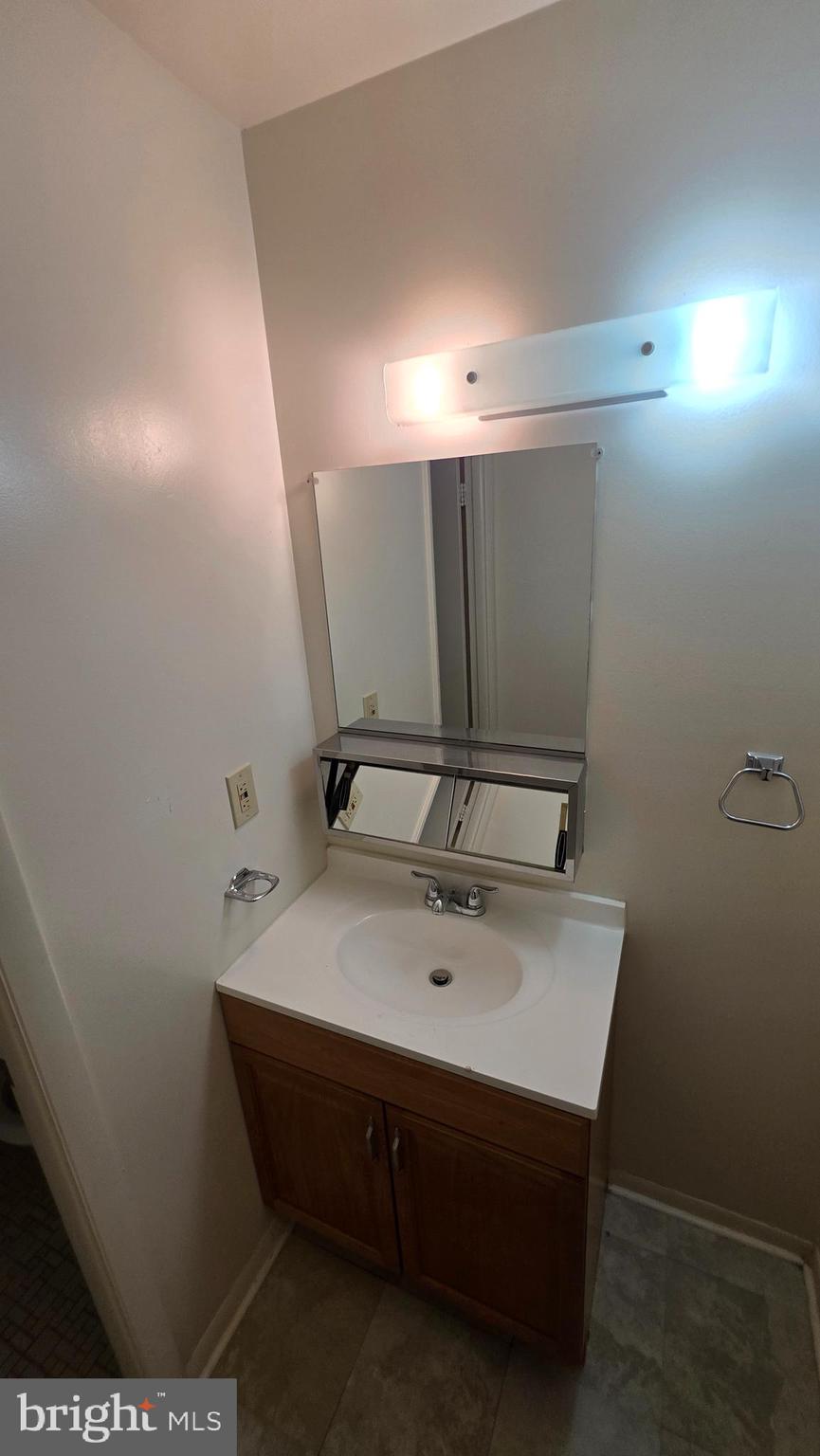 3928 Rolling Rd., Unit C10 Pikesville, MD 21208 - Photo 9 of 26 a bathroom with a sink vanity and mirror