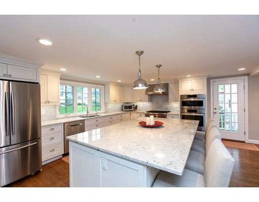 117 Forest Street Wellesley, MA 02481 - Photo 11 of 28 a kitchen with stainless steel appliances granite countertop a refrigerator a sink dishwasher a stove and white cabinets with wooden floor