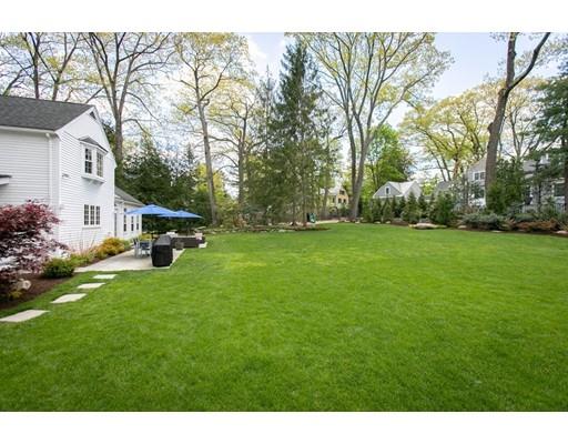 117 Forest Street Wellesley, MA 02481 - Photo 26 of 28 a view of a white house in front of a big yard with large trees