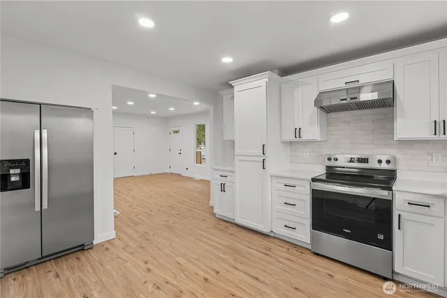 a kitchen with stainless steel appliances a stove and a refrigerator