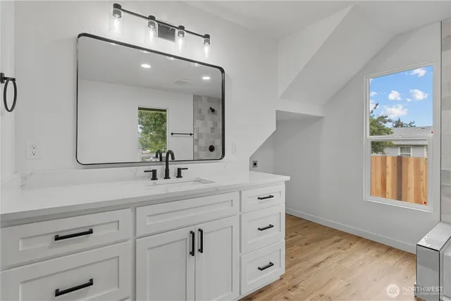 a bathroom with a sink and mirror wooden cabinet