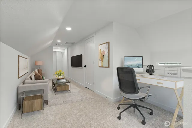 a work room with furniture and a flat screen tv