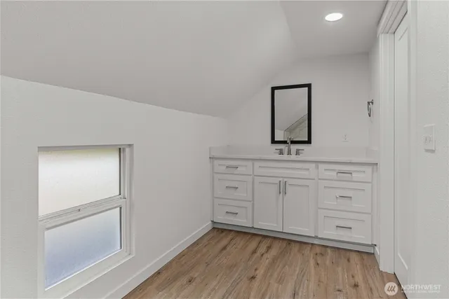 a bathroom with a double vanity sink and mirror