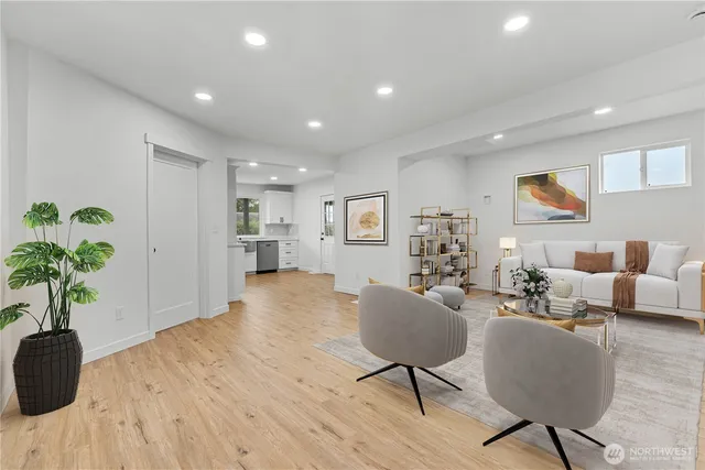 a living room with furniture and a potted plant