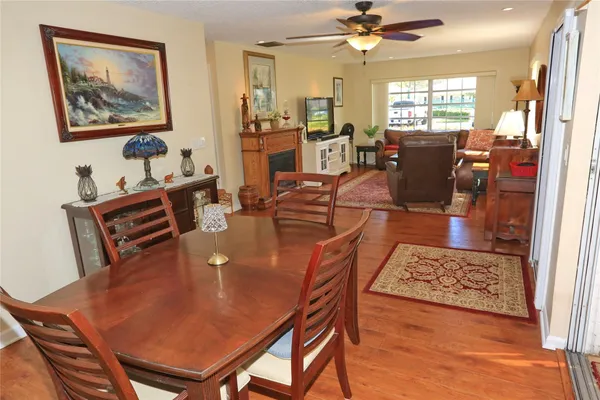 a kitchen with stainless steel appliances cabinets and a wooden floor
