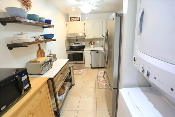 a utility room with dryer washer and wooden floor