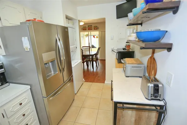a kitchen with granite countertop white cabinets and white appliances