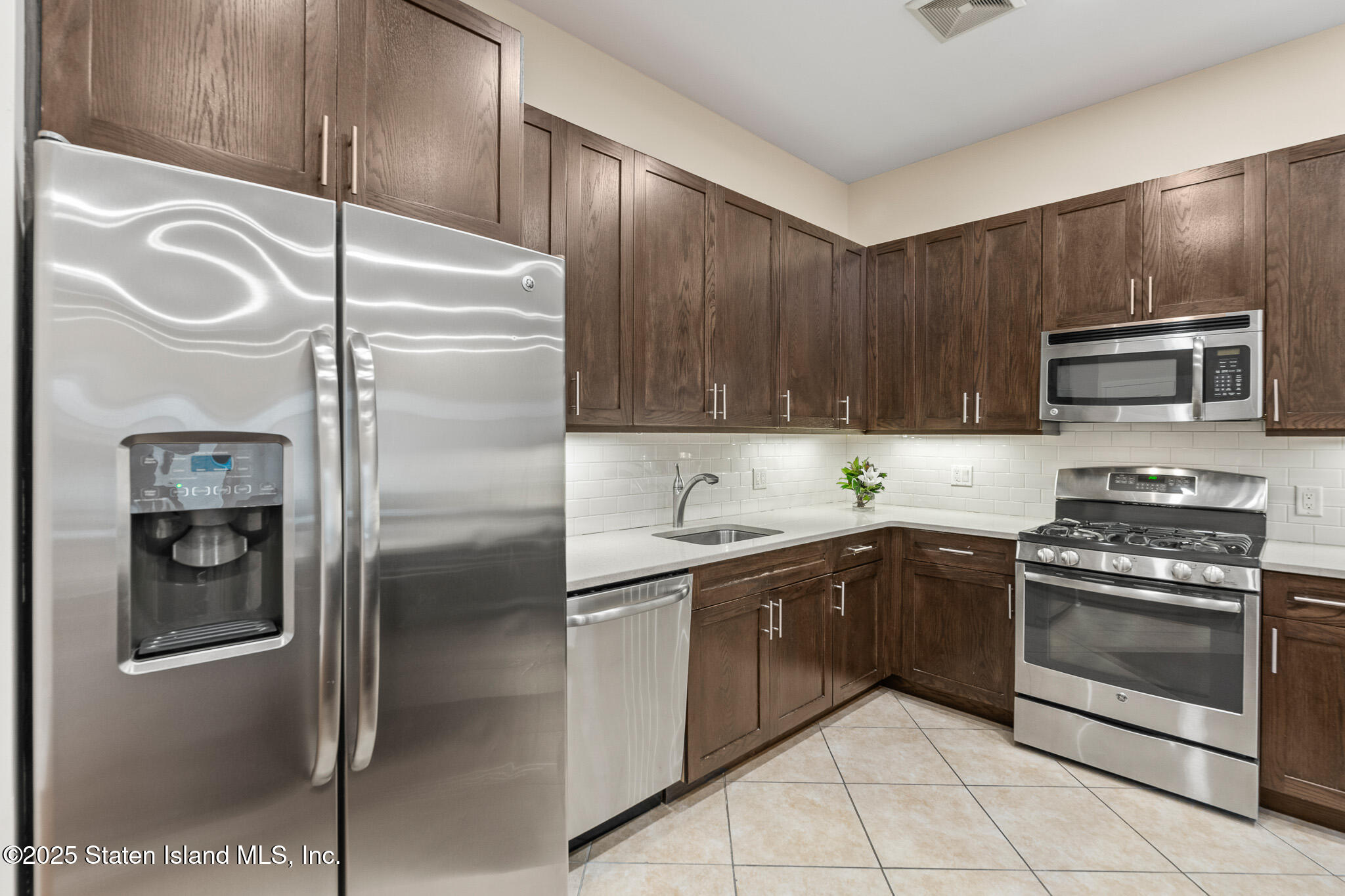 90 Bay Street Landing, Unit 1F Staten Island, NY 10301 - Photo 15 of 55 a kitchen with a refrigerator sink and stove