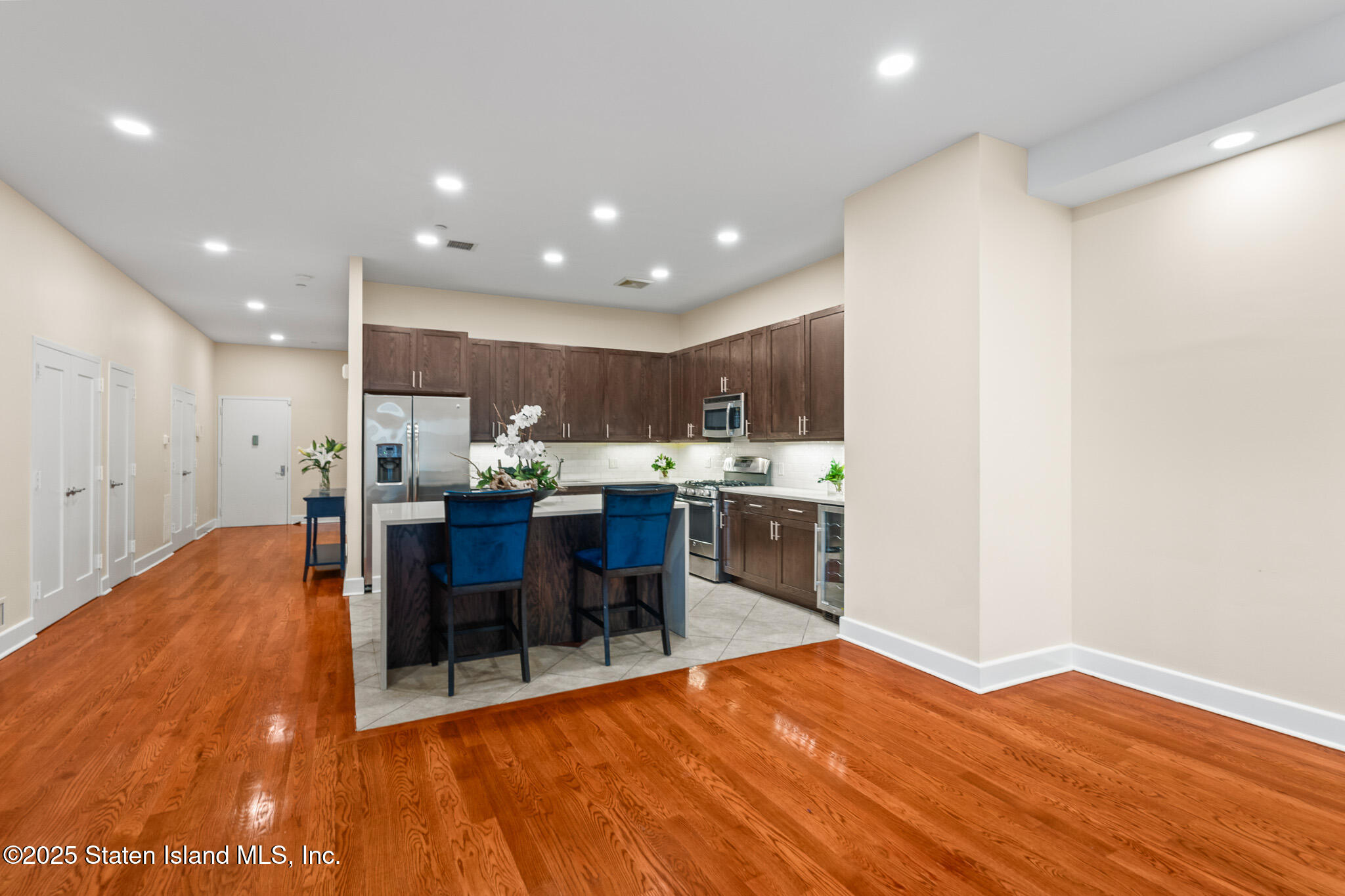 90 Bay Street Landing, Unit 1F Staten Island, NY 10301 - Photo 16 of 55 a view of kitchen with kitchen island dining table and stainless steel appliances
