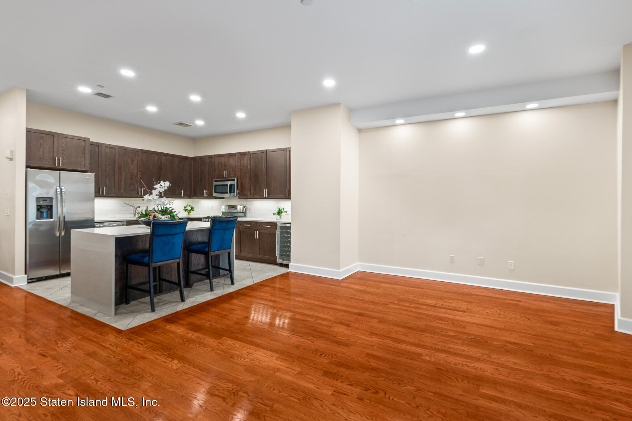 90 Bay Street Landing, Unit 1F Staten Island, NY 10301 - Photo 17 of 55 a open kitchen with kitchen island granite countertop wooden cabinets and stainless steel appliances