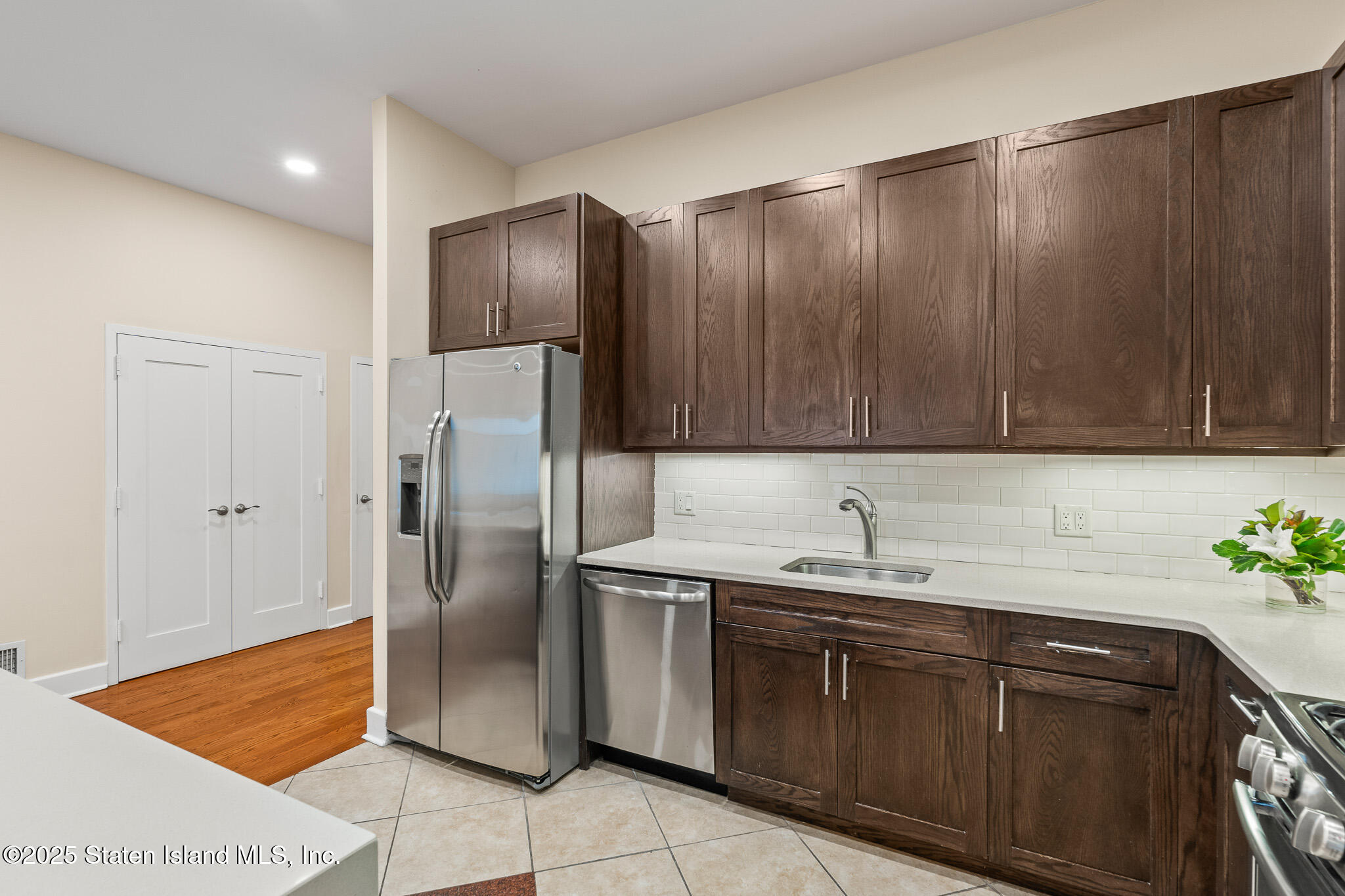 90 Bay Street Landing, Unit 1F Staten Island, NY 10301 - Photo 20 of 55 a kitchen with stainless steel appliances granite countertop a refrigerator and a sink