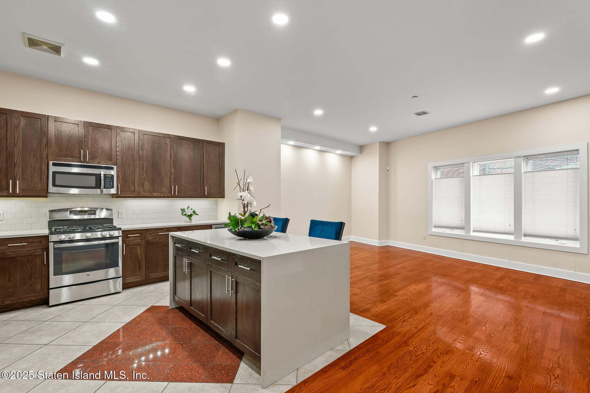 90 Bay Street Landing, Unit 1F Staten Island, NY 10301 - Photo 2 of 55 a kitchen with stainless steel appliances granite countertop a stove a sink and a refrigerator