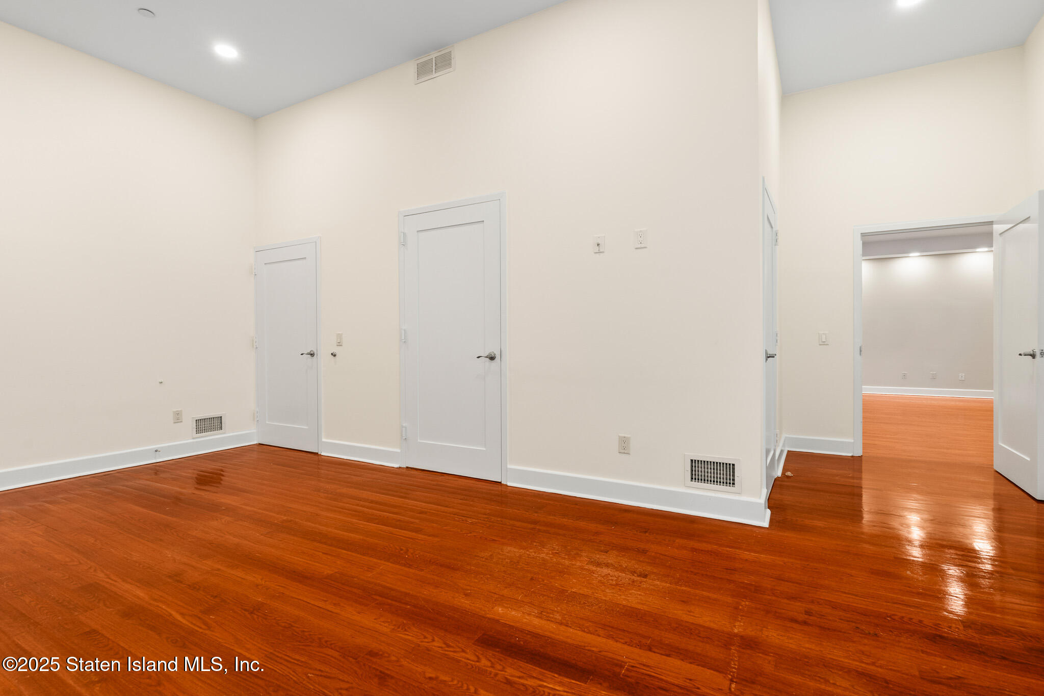 90 Bay Street Landing, Unit 1F Staten Island, NY 10301 - Photo 29 of 55 a view of an empty room with wooden floor