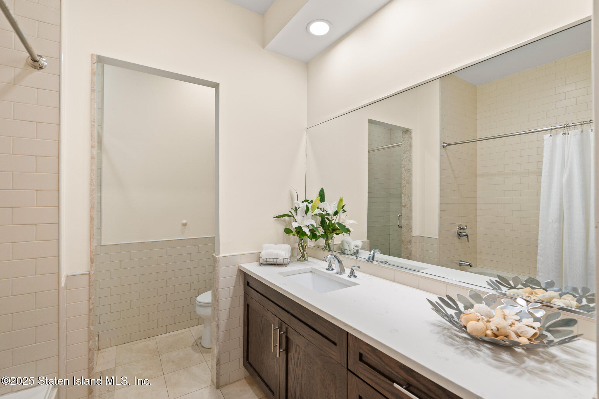 90 Bay Street Landing, Unit 1F Staten Island, NY 10301 - Photo 33 of 55 a bathroom with a sink and a mirror
