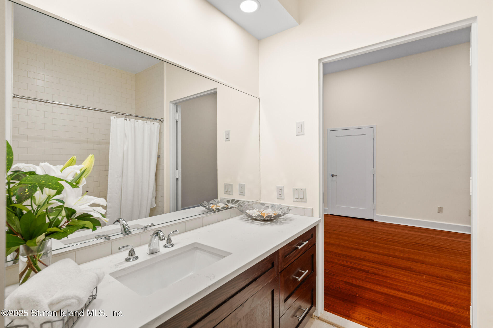 90 Bay Street Landing, Unit 1F Staten Island, NY 10301 - Photo 35 of 55 a bathroom with a sink and a mirror