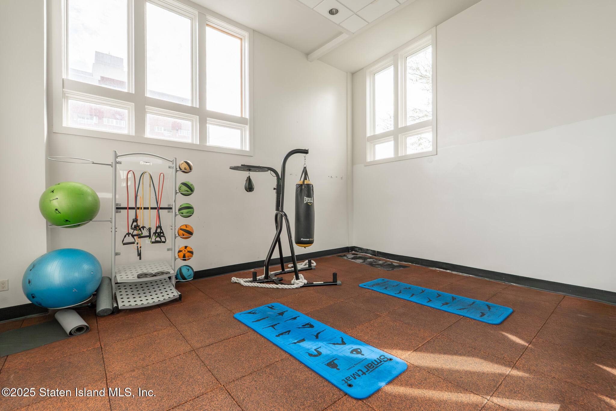 90 Bay Street Landing, Unit 1F Staten Island, NY 10301 - Photo 44 of 55 a room with gym equipment and a window