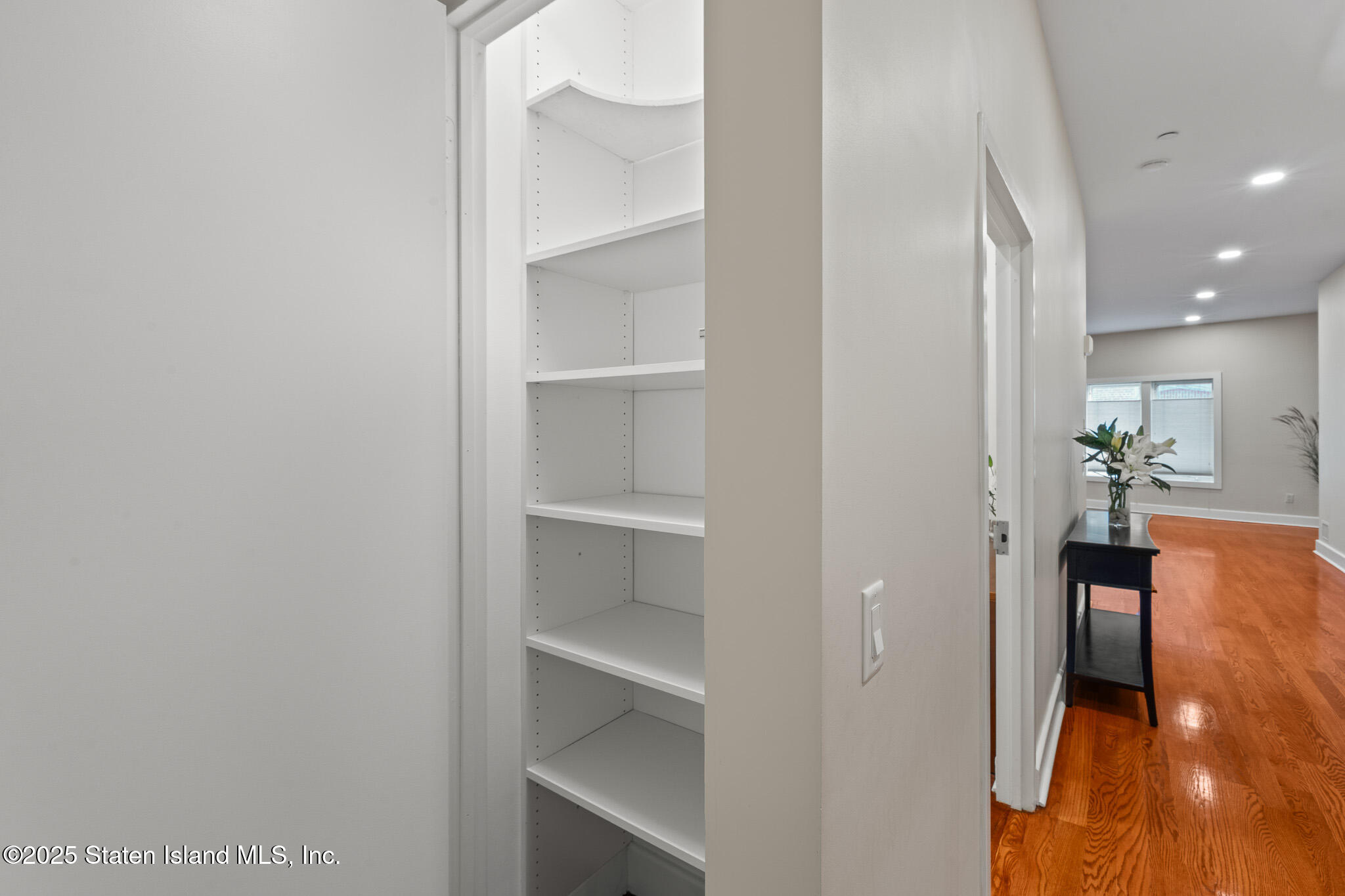 90 Bay Street Landing, Unit 1F Staten Island, NY 10301 - Photo 7 of 55 a view of a hallway with wooden floor and a bathroom