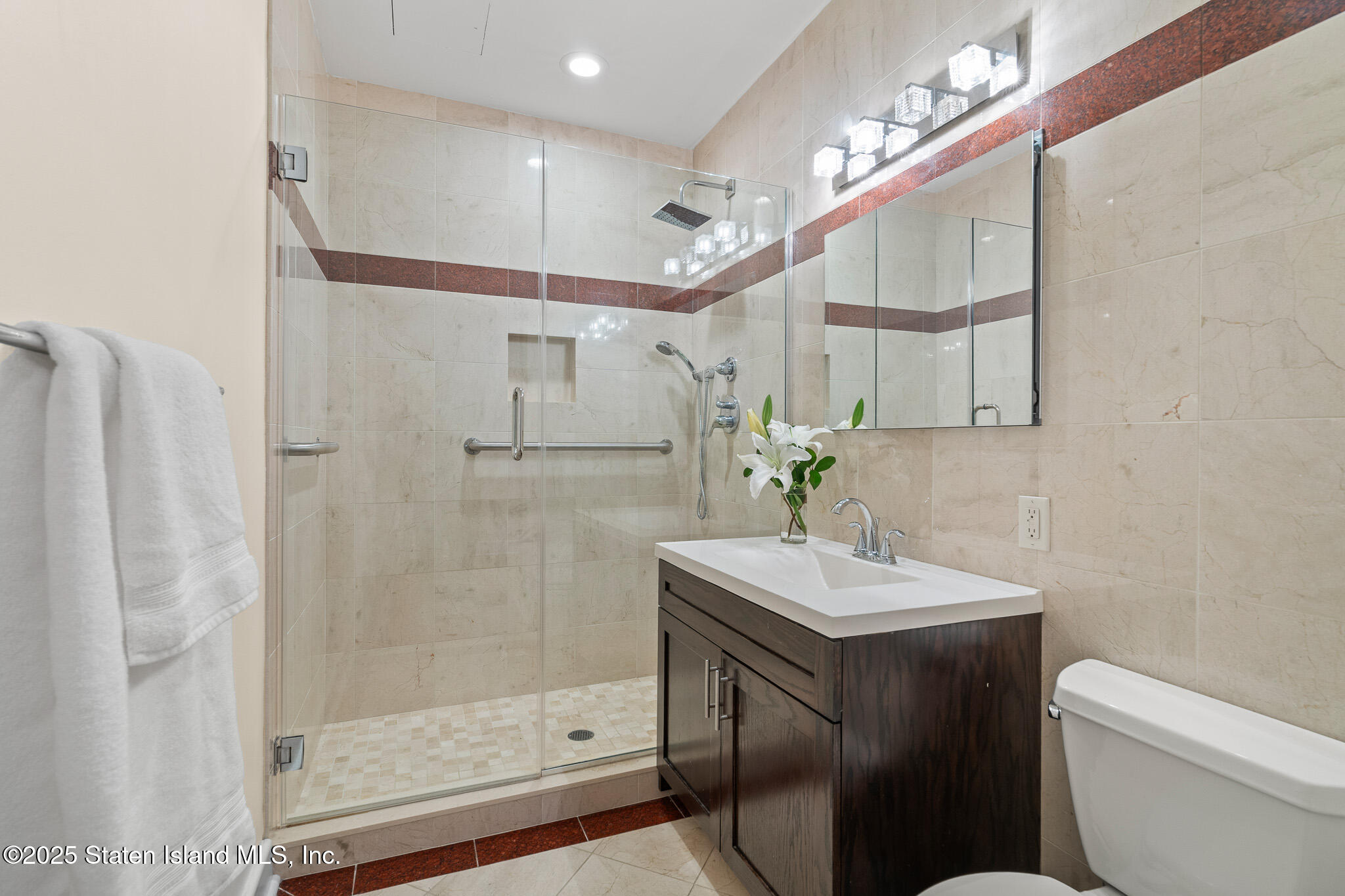 90 Bay Street Landing, Unit 1F Staten Island, NY 10301 - Photo 9 of 55 a bathroom with a sink vanity mirror and toilet