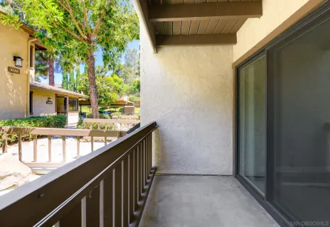 a view of balcony with wooden floor and fence