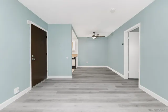 a view of empty room with wooden floor