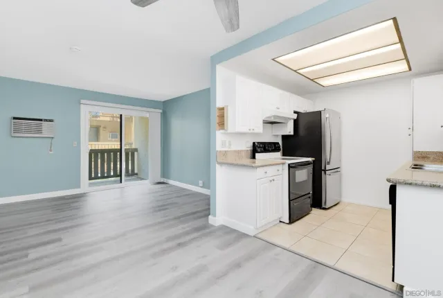 a kitchen with a refrigerator a stove top oven a sink dishwasher and wooden cabinets