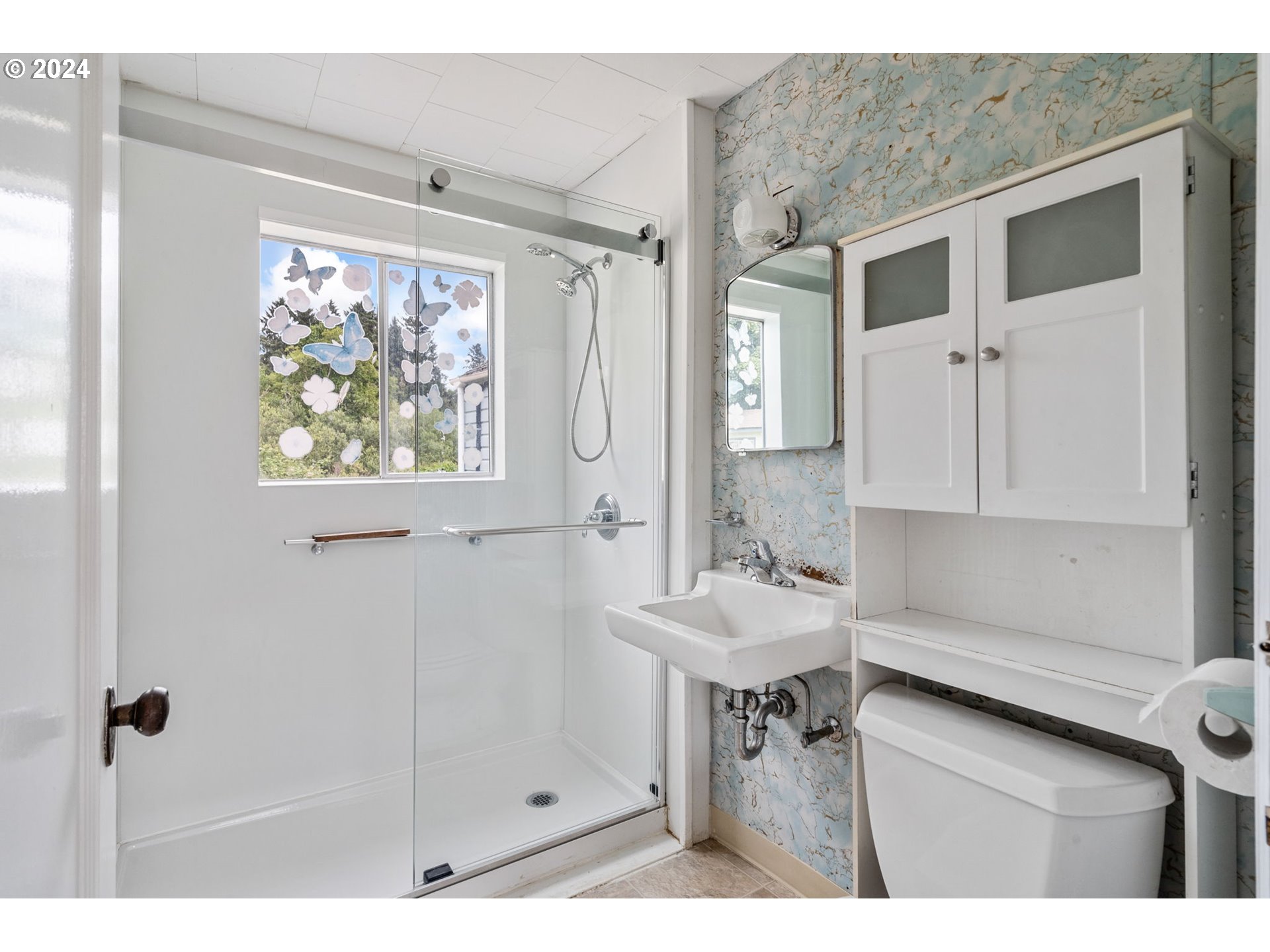 92165 Clover Road Astoria, OR 97103 - Photo 16 of 31 a bathroom with a sink a mirror and a shower