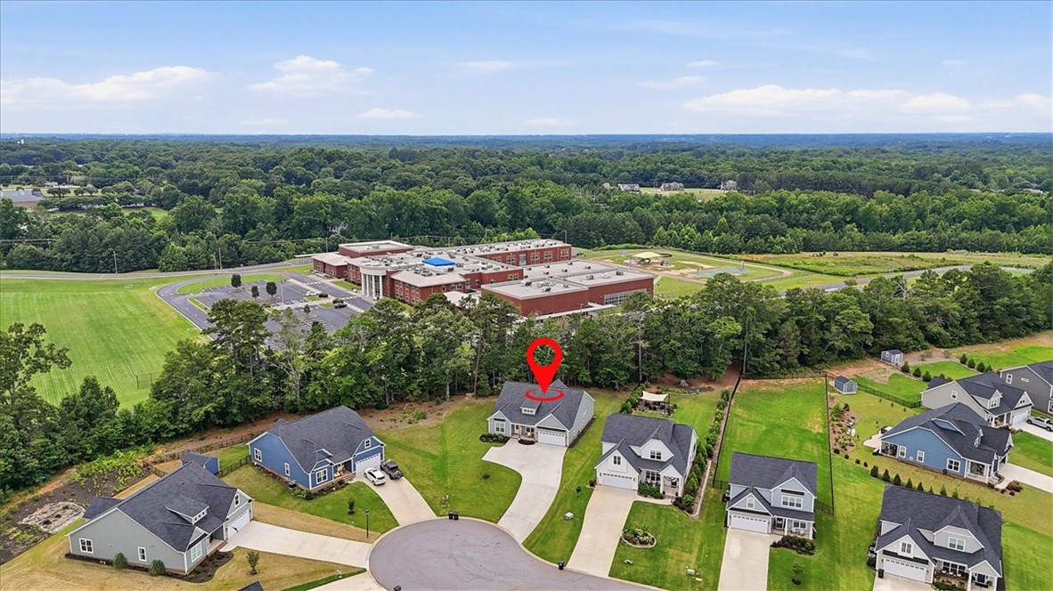 214 Timothy Court Anderson, SC 29621 - Photo 39 of 43 An aerial perspective reveals a cul-de-sac community nestled beside a verdant school sports field.