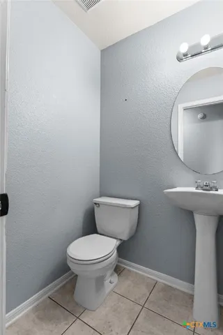 a bathroom with a toilet and a sink