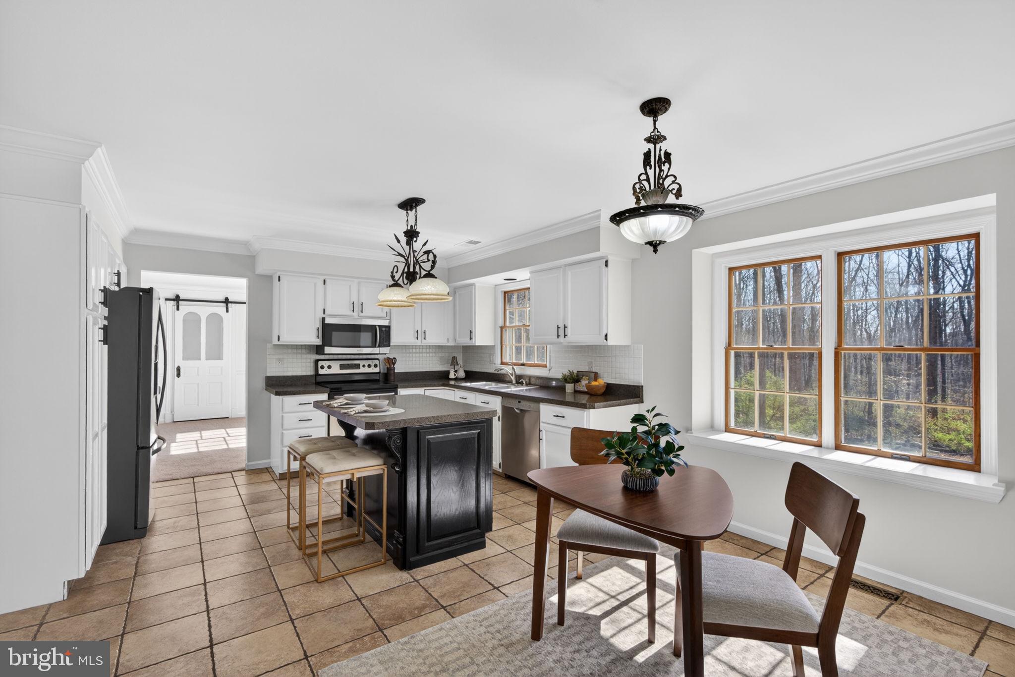 2635 Possum Hollow Road Quakertown, PA 18951 - Photo 41 of 78 a view of a dining room with furniture and a chandelier