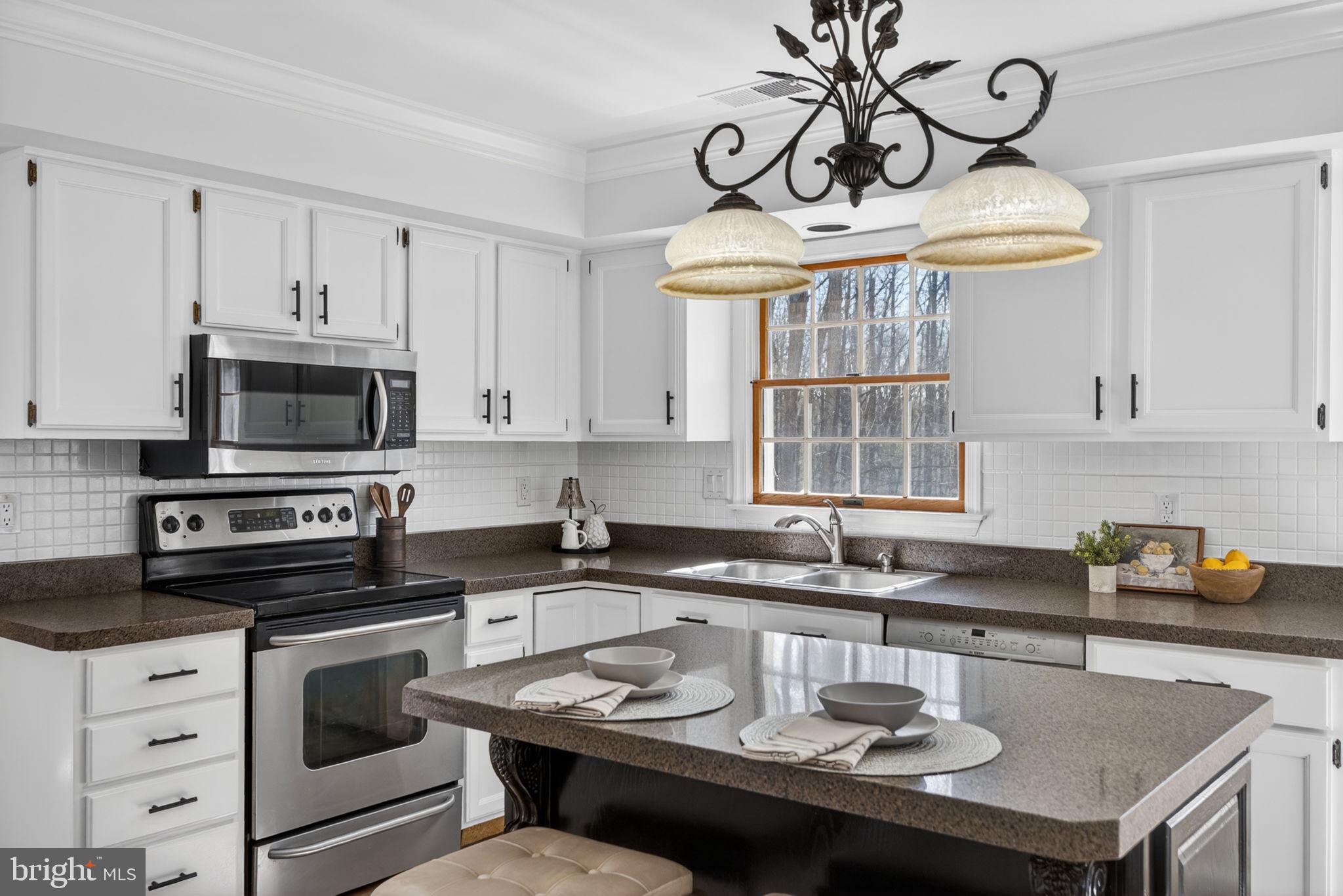 2635 Possum Hollow Road Quakertown, PA 18951 - Photo 44 of 78 a kitchen with stainless steel appliances granite countertop a sink a stove and a microwave