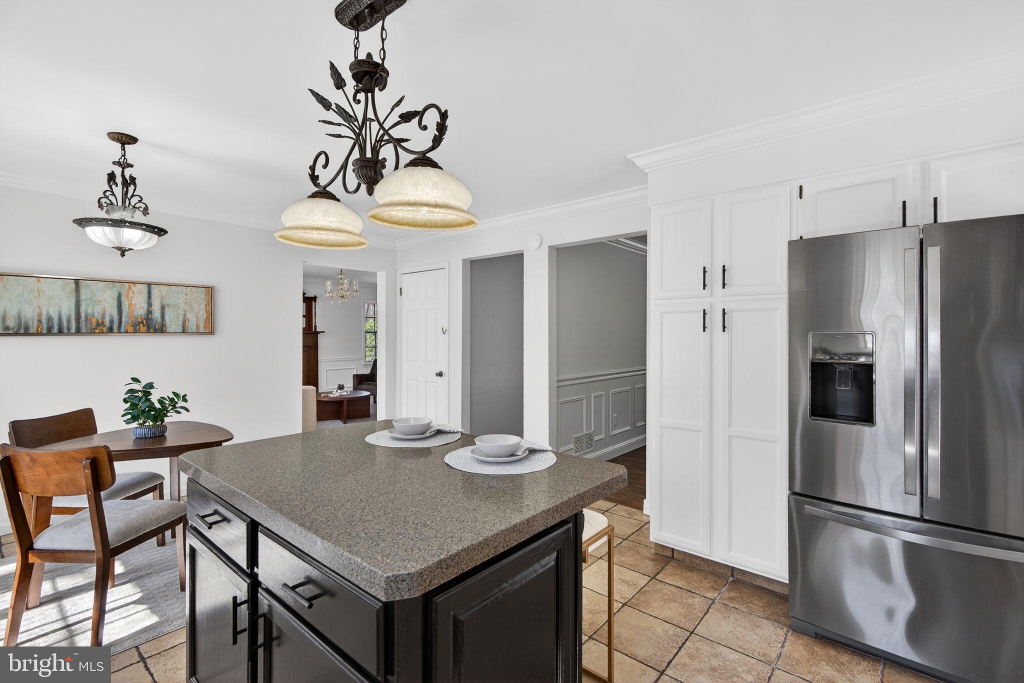 2635 Possum Hollow Road Quakertown, PA 18951 - Photo 52 of 78 a kitchen with stainless steel appliances granite countertop a dining table and chairs