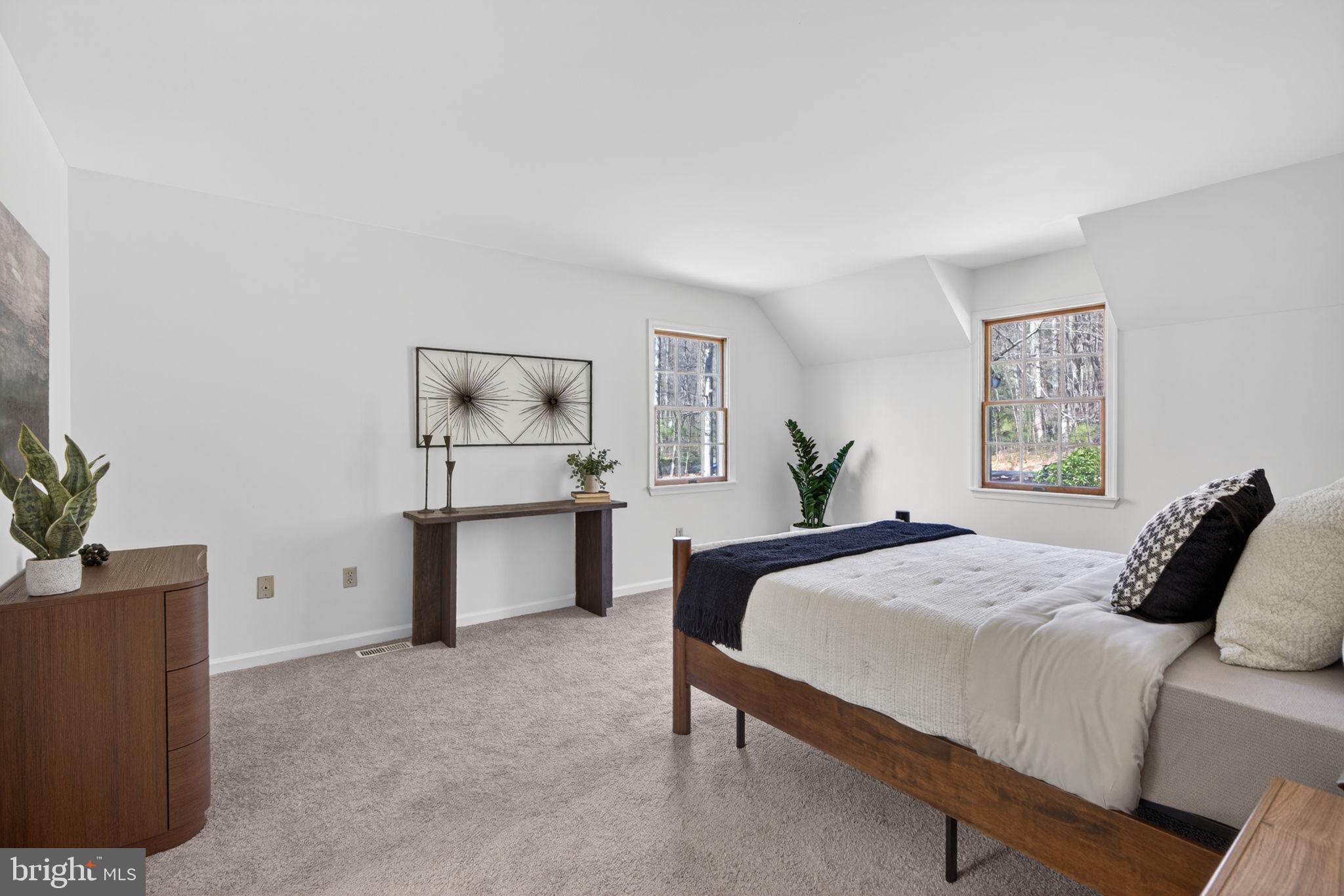 2635 Possum Hollow Road Quakertown, PA 18951 - Photo 62 of 78 a bedroom with a large bed and paintings on the wall