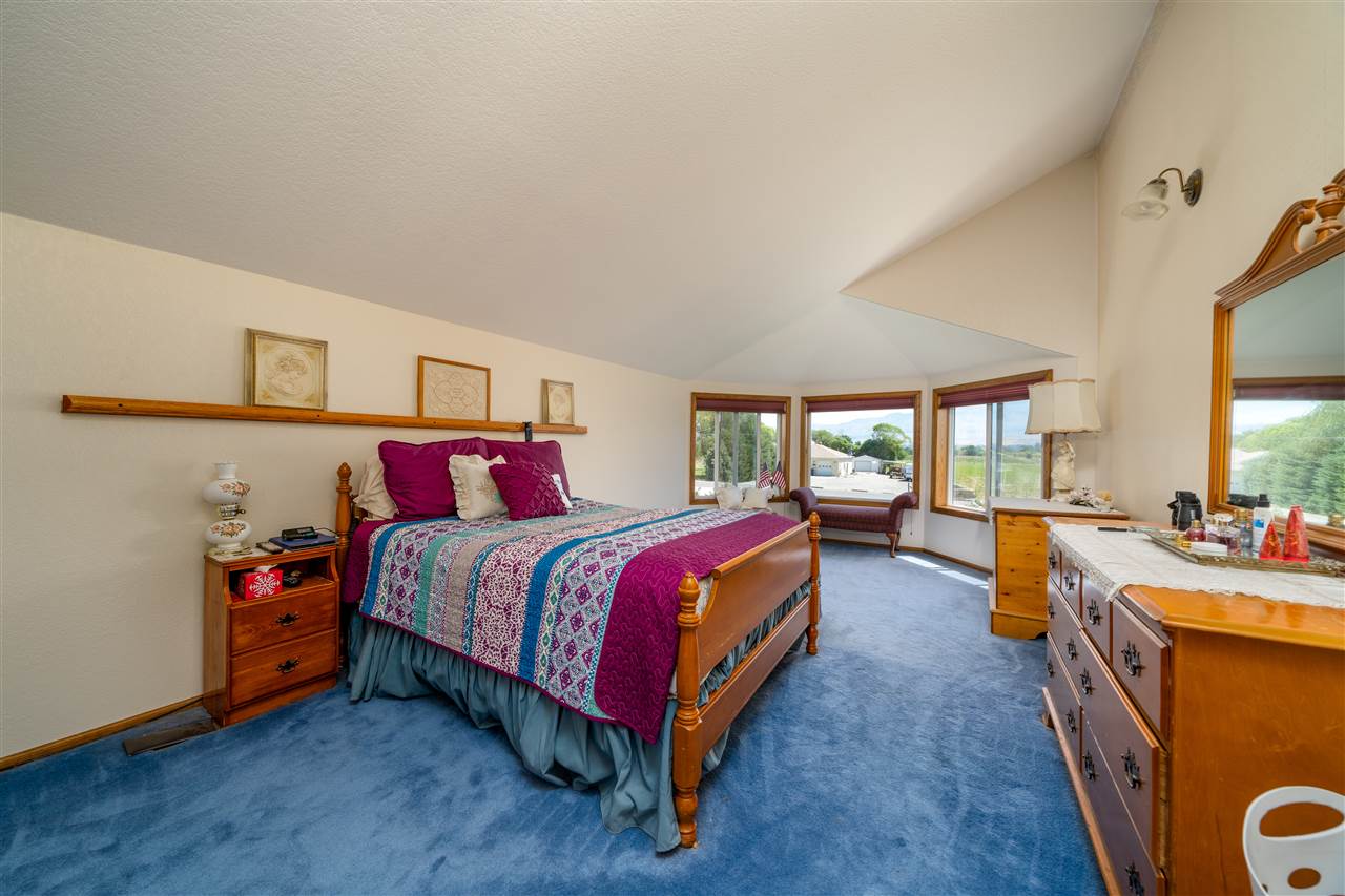 581 34 Road Clifton, CO 81520 - Photo 19 of 42 a spacious bedroom with a bed and a large window
