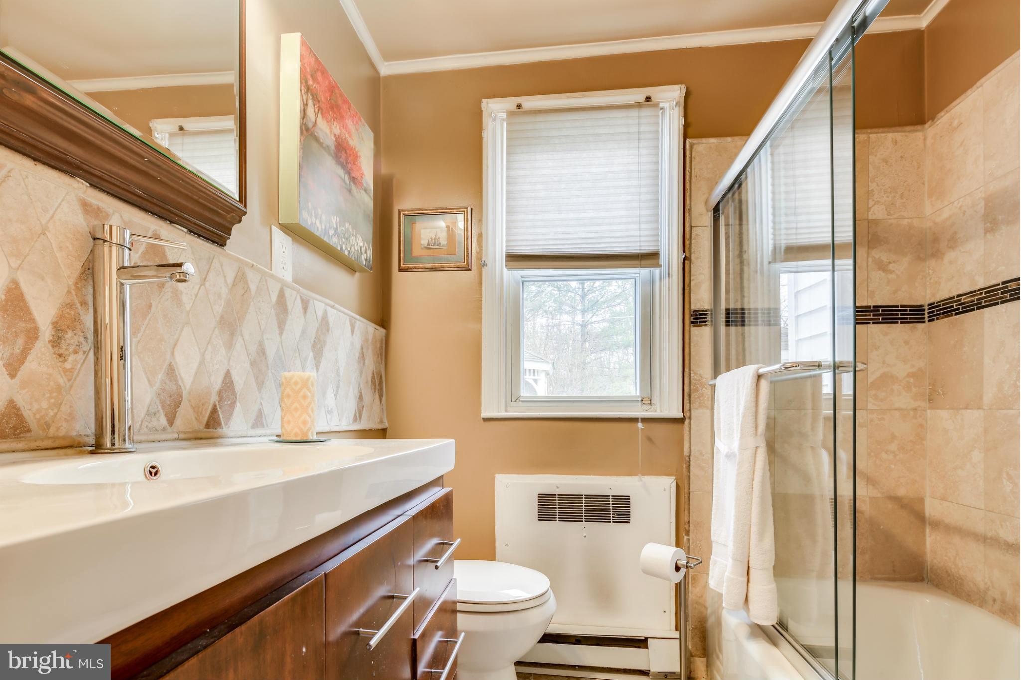 732 Warwick Road Baltimore, MD 21229 - Photo 14 of 30 a bathroom with a sink a toilet and a window