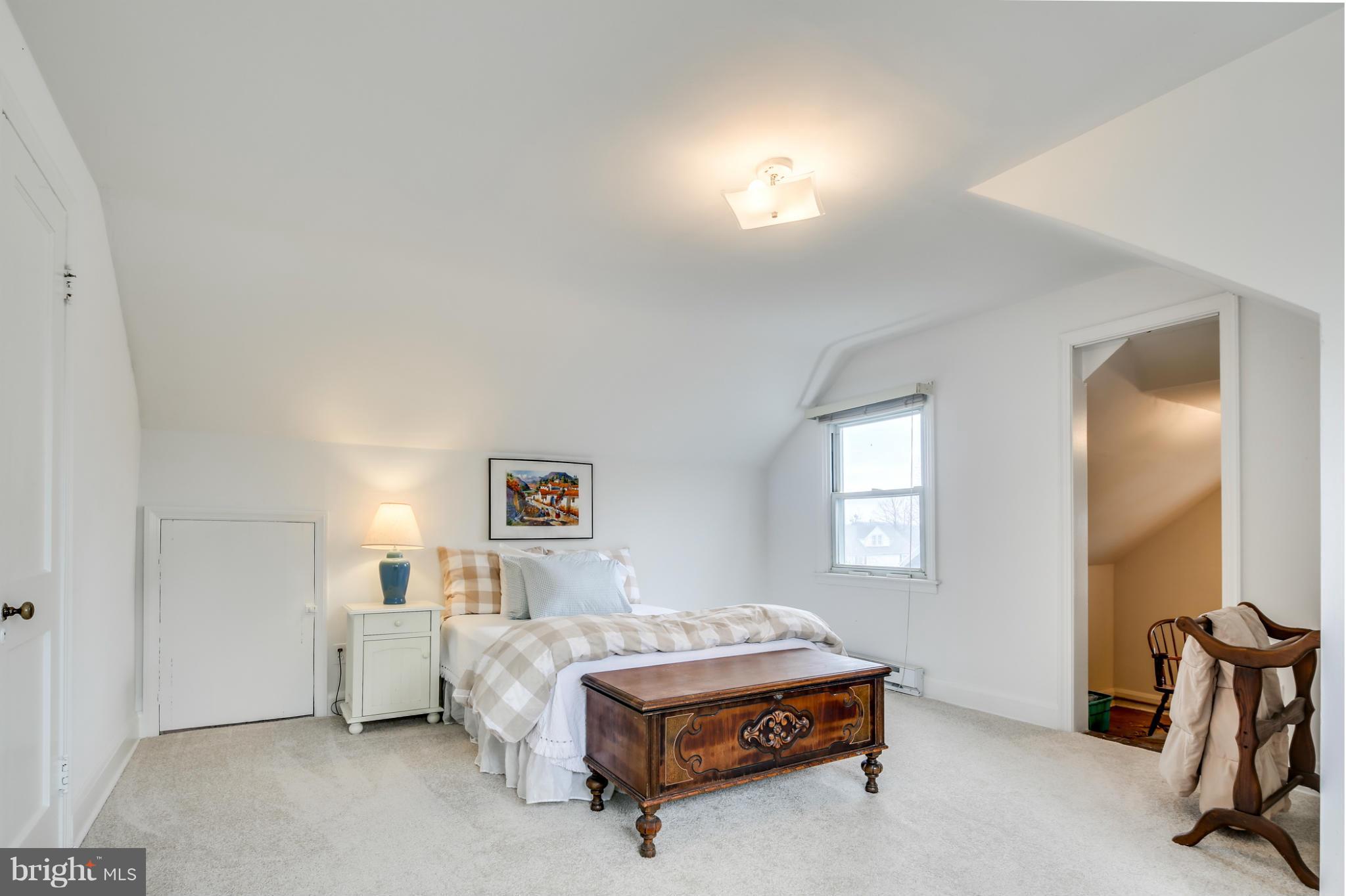 732 Warwick Road Baltimore, MD 21229 - Photo 21 of 30 a spacious bedroom with a bed and a lamp