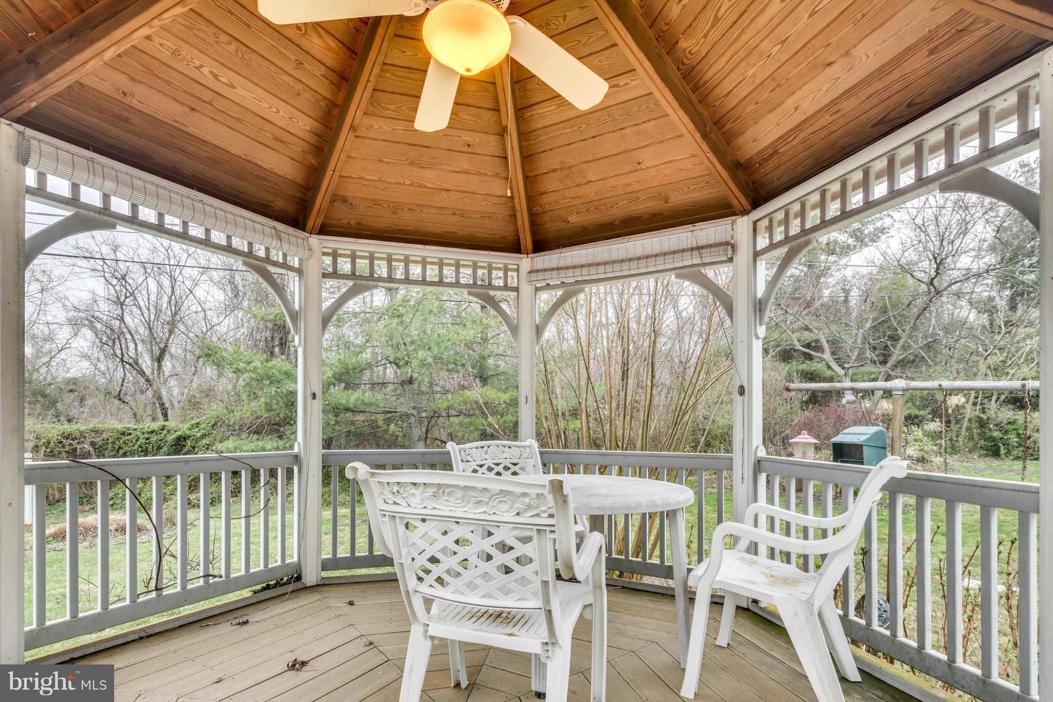 732 Warwick Road Baltimore, MD 21229 - Photo 29 of 30 a view of a patio with a table chairs and wooden floor