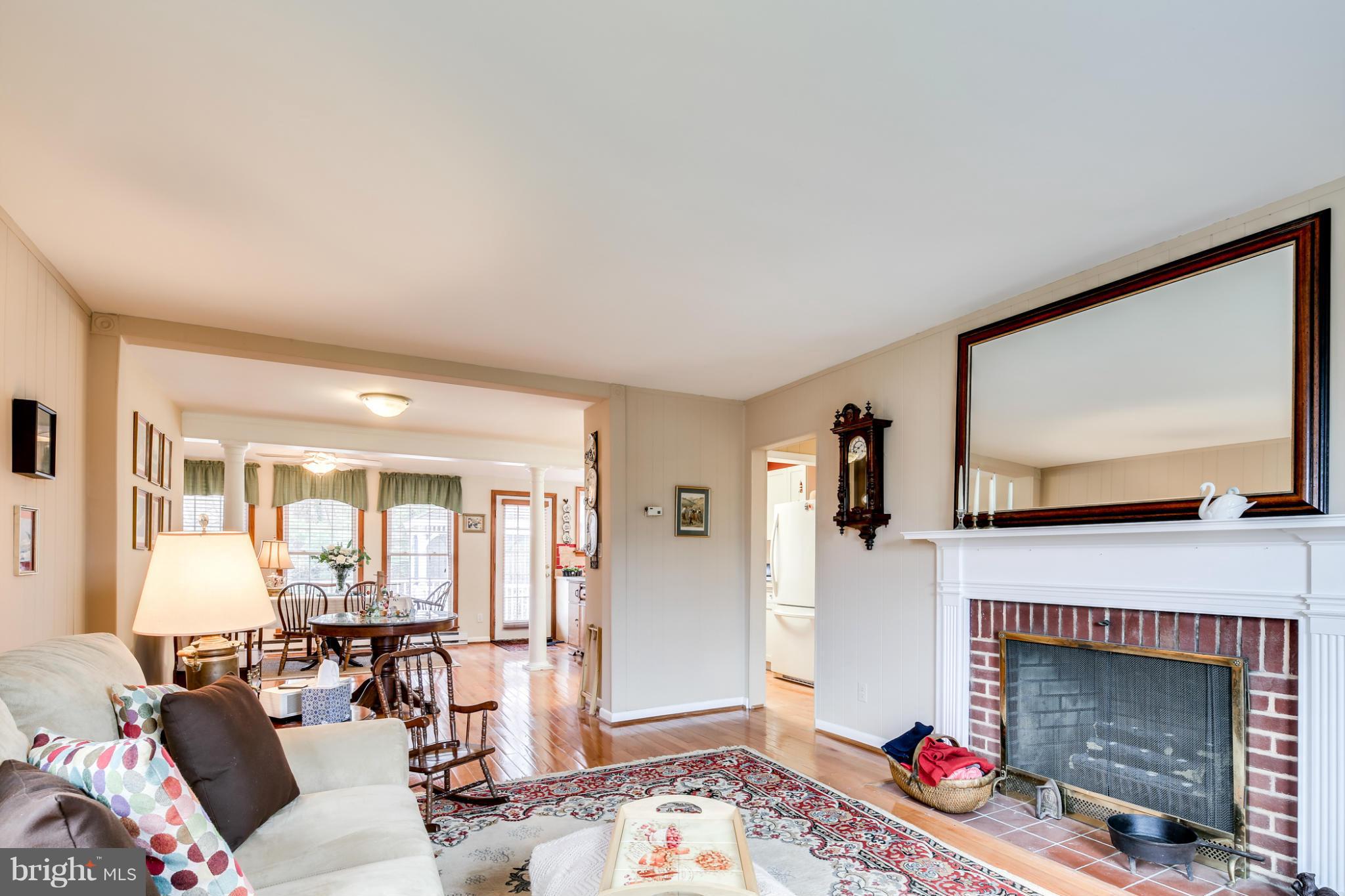 732 Warwick Road Baltimore, MD 21229 - Photo 4 of 30 a living room with furniture a flat screen tv and a fireplace