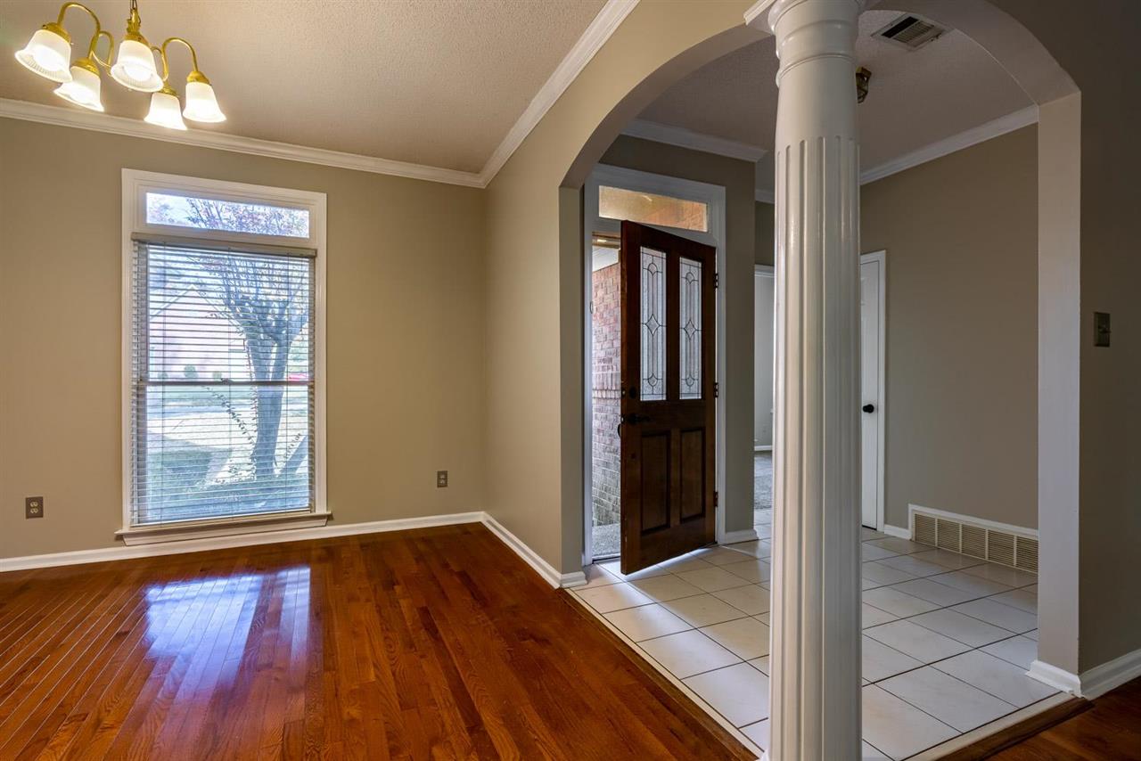 8779 Raspberry Lane Memphis, TN 38016 - Photo 4 of 25 wooden floor in an empty room with a window