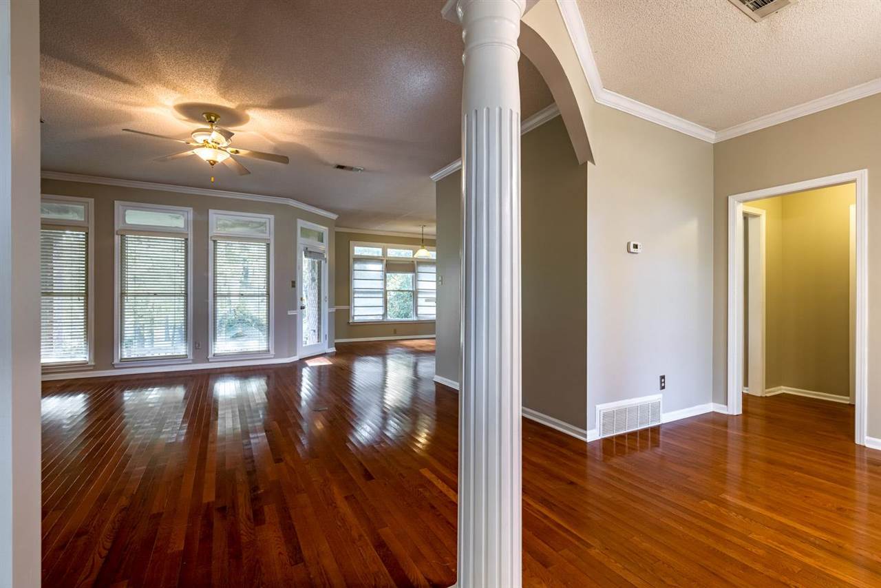 8779 Raspberry Lane Memphis, TN 38016 - Photo 5 of 25 wooden floor in an empty room with a window