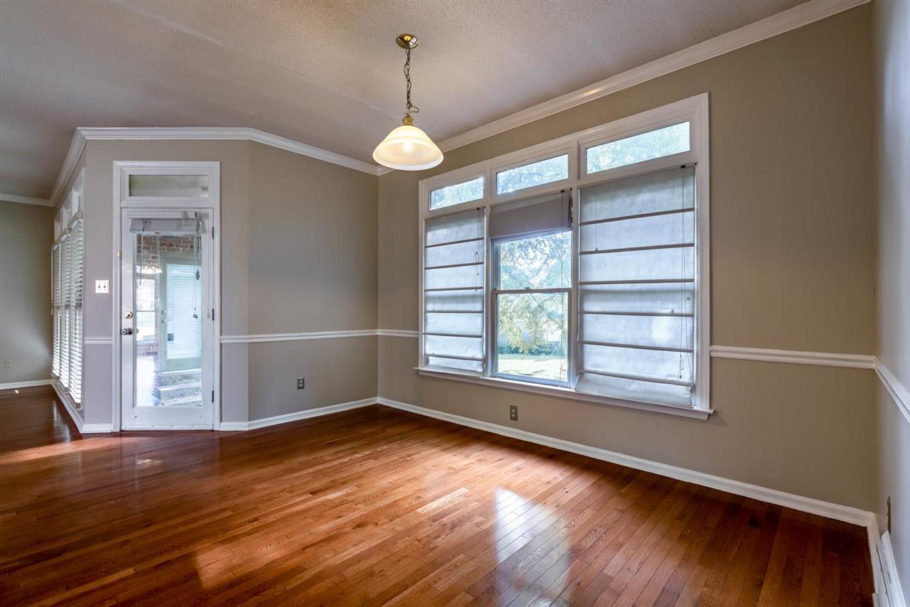 8779 Raspberry Lane Memphis, TN 38016 - Photo 9 of 25 an empty room with wooden floor and windows