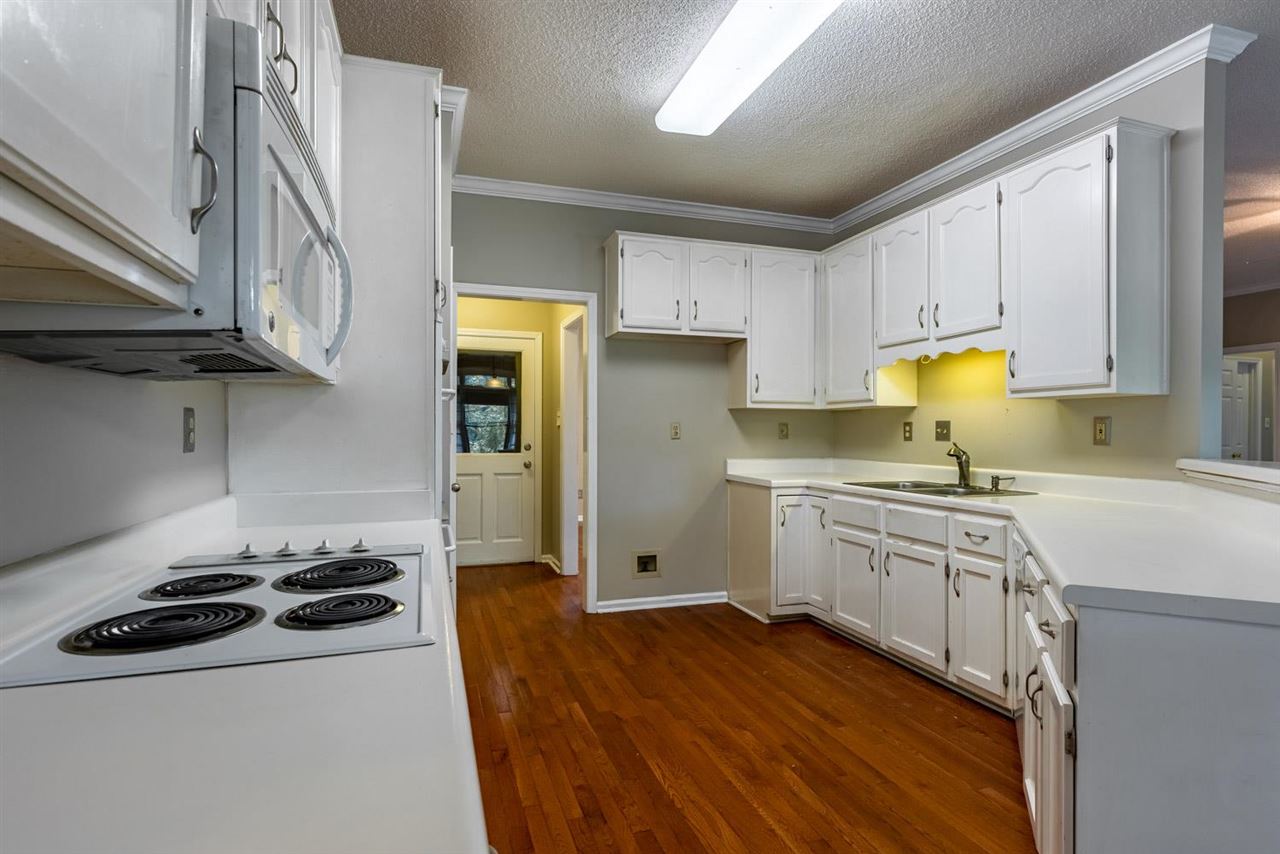 8779 Raspberry Lane Memphis, TN 38016 - Photo 10 of 25 a kitchen with stainless steel appliances granite countertop a sink stove and refrigerator