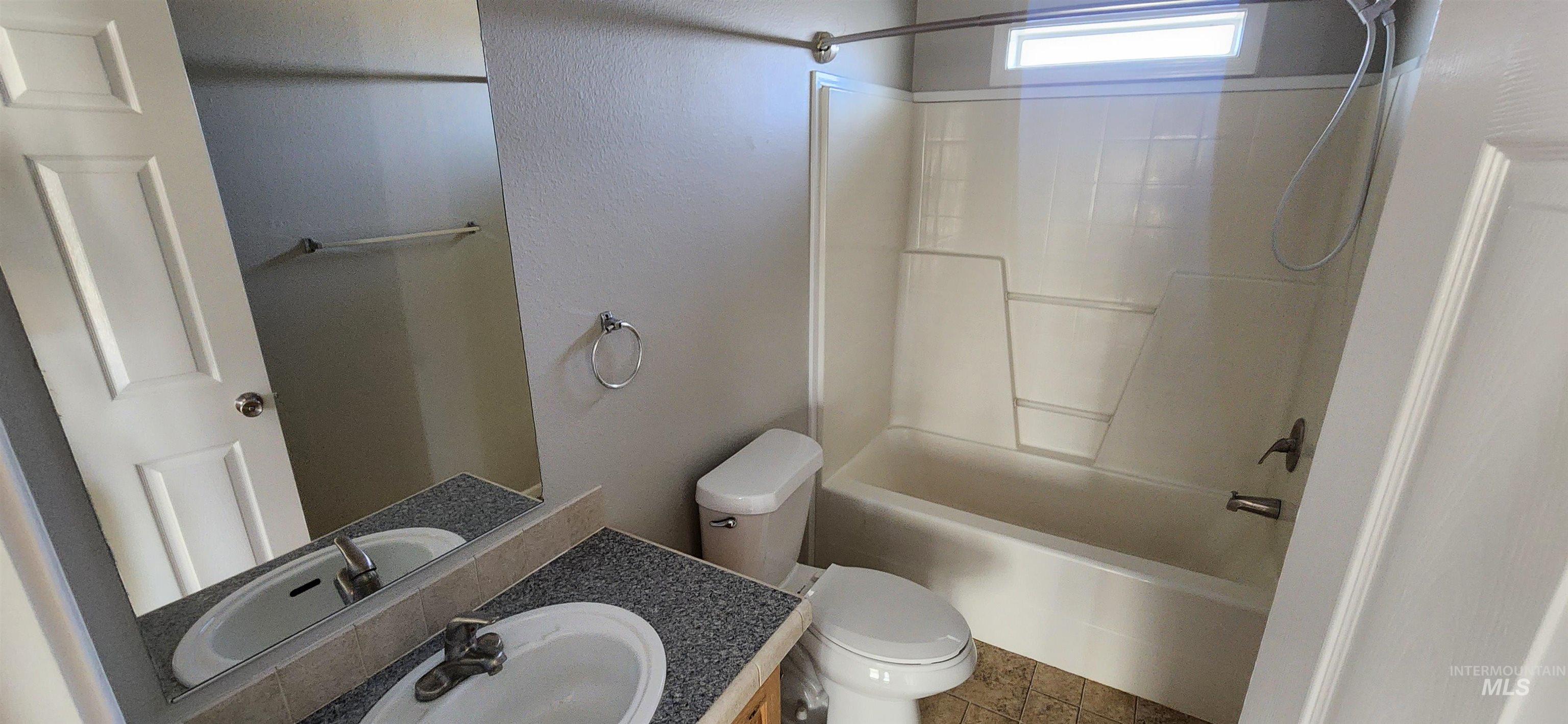 1817 South Exeter Road Council, ID 83612 - Photo 12 of 21 Bathroom with bathing tub / shower combination, vanity, a textured wall, and tile patterned floors