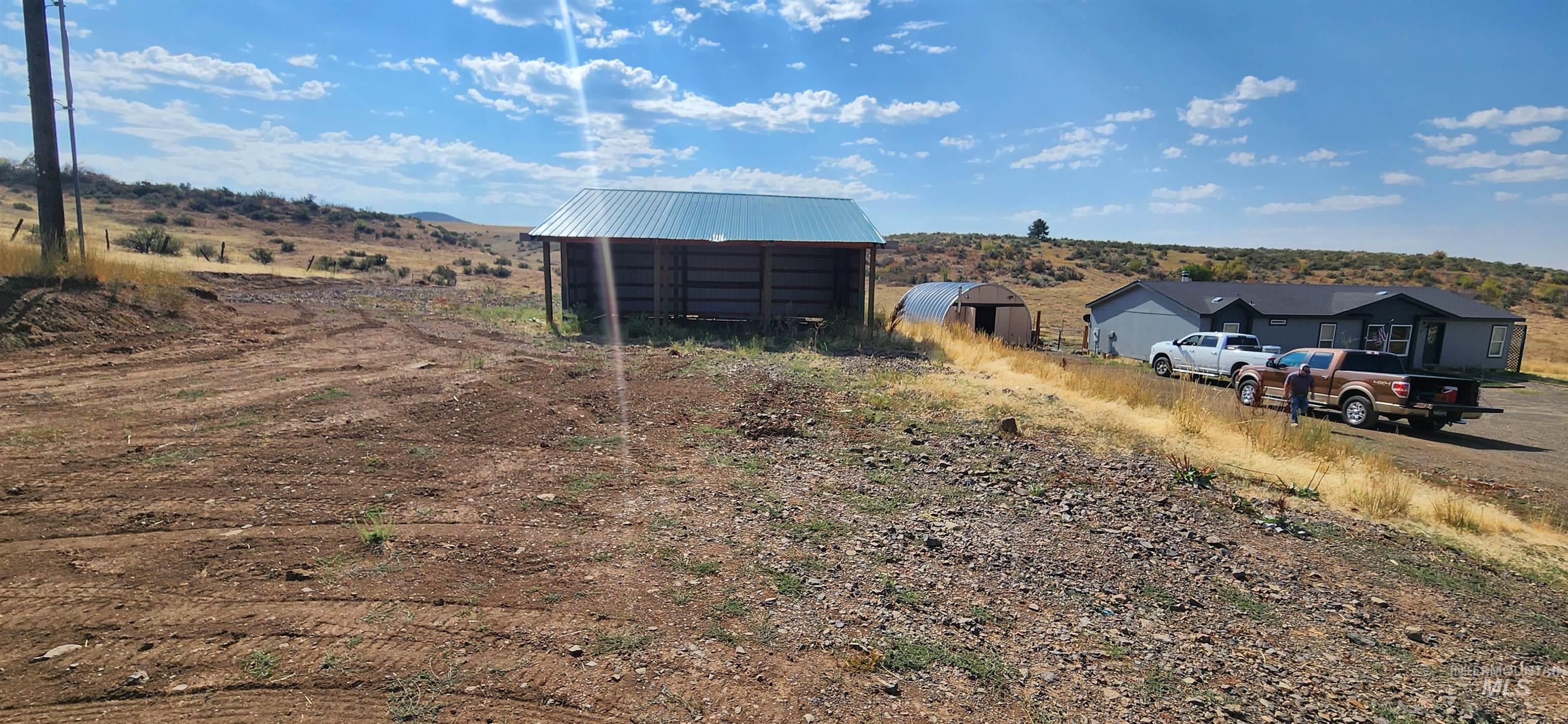 1817 South Exeter Road Council, ID 83612 - Photo 3 of 21 View of yard featuring a pole building, an outdoor structure, and a view of countryside